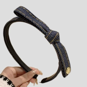 Dark blue denim knotted headband with gold stitching and side button accessory
