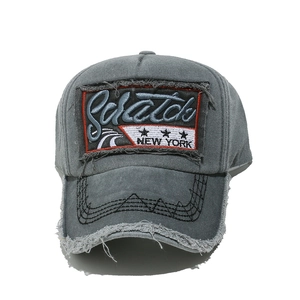 Detail of vintage gray baseball cap with 3D Scratch New York embroidery and frayed brim