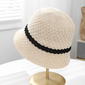 Detailed knit texture of breathable beige bucket hat with black stripe trim