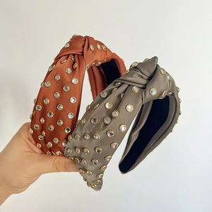 Knotted satin headbands with sparkling rhinestones in caramel orange and olive green