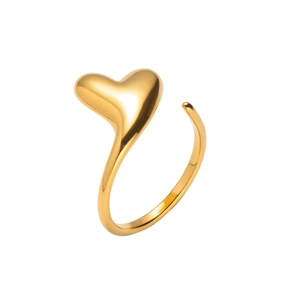 Macro detail of gold-plated heart ring featuring a high-polish finish and adjustable band