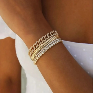 Detail of 10mm wide gold tennis chain set with pave crystals and stacked Cuban link