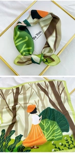 Detailed view of square silk scarf featuring a colorful fairy tale illustration and border