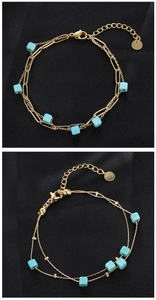 Detail of vintage gold chain bracelet with turquoise cubic beads and lobster clasp