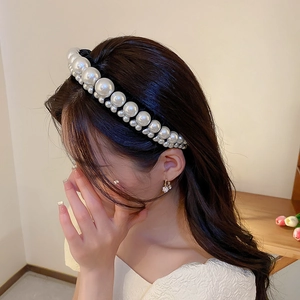 Detail of French vintage velvet headband with gradient white pearls on model