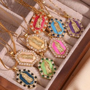Macro shot of 18K gold plated Virgin Mary pendants with colorful enamel in hexagon settings