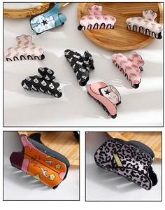 Detailed set of retro hair claws with cowgirl boots and leopard patterns on wooden tray