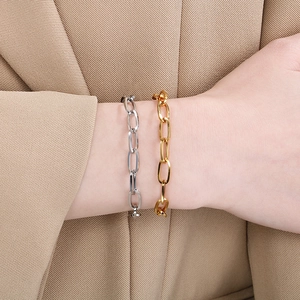 Gold and silver chunky rectangle link chain bracelets shown on a model wrist