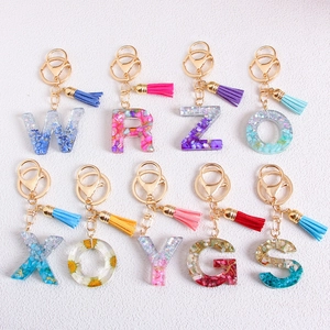 Handmade resin alphabet keychains with glitter, gold leaf and tassel charms