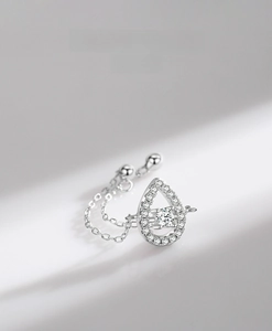 Detailed close-up of water drop ring featuring floating diamond and pavé settings