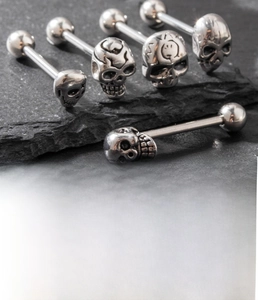Detailed view of silver titanium steel barbell featuring a cast skull head and ball end