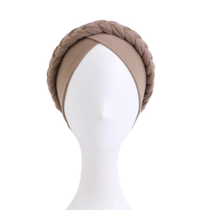 Detail of a brown braided turban headwear with high-elasticity knit fabric on model