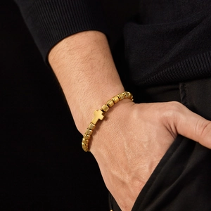 Men's gold stainless steel adjustable bead bracelet with cross pendant on wrist