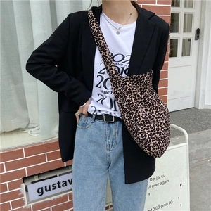 Chic leopard print canvas shoulder bag with large capacity shown on a model for style