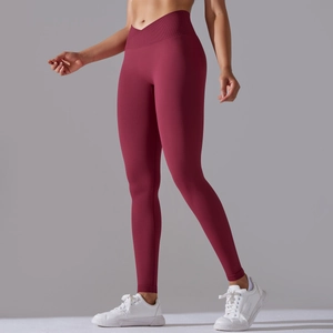 Close-up of seamless burgundy yoga pants featuring a cross V-waist and ribbed texture