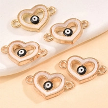 Golden heart-shaped evil eye connectors with white enamel for jewelry making