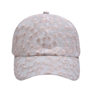 Detail of pink and white mesh baseball cap featuring intricate daisy lace embroidery