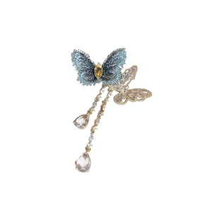 Elegant gold butterfly brooch with blue velvet wings and dangling water drop zircons