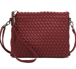 Macro detail of wine red woven leather clutch with silver zipper and wrist strap