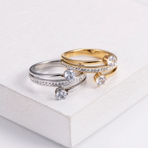 Elegant gold and silver spiral rings featuring sparkling cubic zirconia on stone base