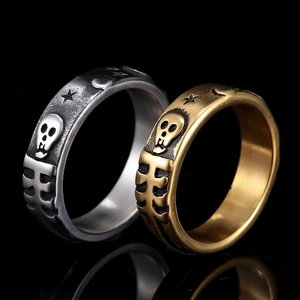 Vintage stainless steel skull and star rings in silver and gold finish with reflection