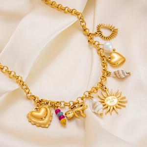 18k gold plated sun and shell charm necklace with colorful beads on a satin backdrop
