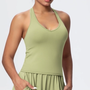 Detail of avocado green yoga vest with V-neck cross-back straps and elastic hem