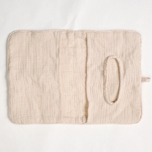 Detailed macro view of beige muslin cotton bedside storage bag with tissue dispenser