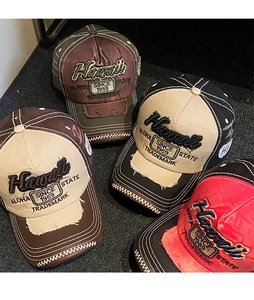 Overhead view of vintage embroidered baseball caps in various distressed color options