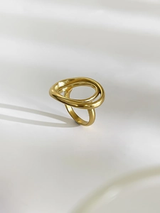Macro shot of gold multi-layered wrap ring with polished sculptural open design