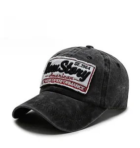 Detailed 45-degree view of dark grey washed denim baseball cap with vintage embroidery