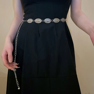 Silver metal oval link waist chain with butterfly accent shown on a black dress