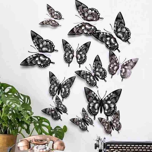 Detail view of 12 black and white 3D hollow butterfly wall stickers in various sizes