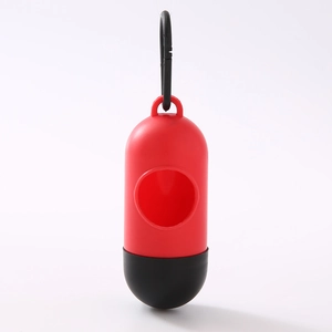Detail of red and black capsule dog waste bag dispenser with portable clip