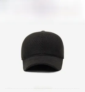 Detail of grey wool baseball cap showing thick felt texture and side metal emblem