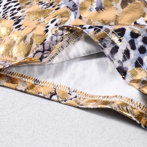 Close-up of gold leopard print fabric showing high-quality sewing and metallic texture