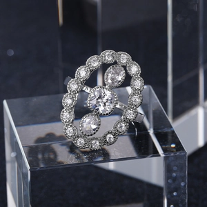 Macro view of luxurious silver oval ring with intricate hollow design and zircon inlay