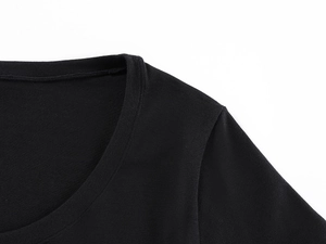 Close-up of the U-neck and shoulder stitching on a black soft-knit slim fitness t-shirt