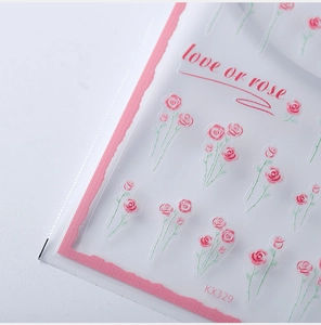Close-up of delicate pink rose 3D nail art stickers with decorative love or rose text