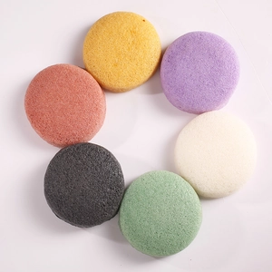 Six colorful hemispherical konjac sponges for deep facial cleansing on white background
