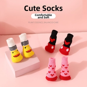 Close-up of three pairs of soft knitted cotton pet socks with colorful fun patterns