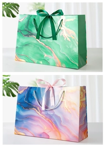 Detail of marble pattern gift bags with elegant ribbon bows and Happy Times text