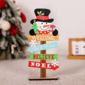 Detail of wooden Christmas snowman sign with snowflakes, gift boxes and Welcome text