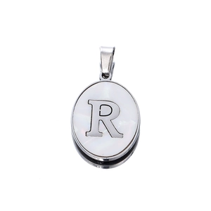 Detailed view of silver oval pendant featuring a mother-of-pearl inlay and letter R engraving