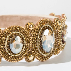 Macro detail of baroque rhinestone headband with gold bead embroidery and sequins