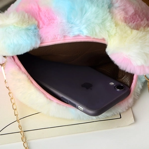 Rainbow plush crossbody bag showing interior capacity with a smartphone inside