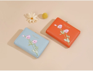 Short PU leather wallets in light blue and orange with floral embroidery by Baellerry