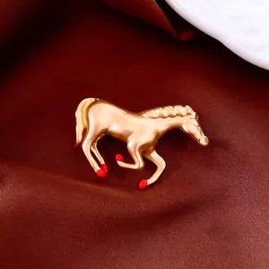 New Chinese style matte gold horse brooch with red enamel on dark red silk