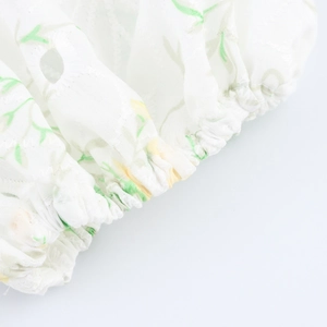 White V-neck maxi dress with green floral embroidery and elastic puff sleeve detail