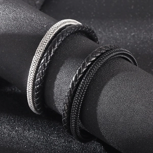 Detail of multi-layer woven leather and stainless steel bracelets with magnetic clasp